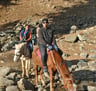 a man riding a horse in the mountains