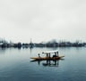 a shikara in the lake with a person on it