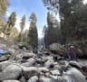 a person standing on a rocky river bank