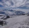 a person standing on a snowy mountain top