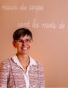 a woman in a pink shirt and glasses