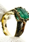 a ring with a green EMERALD stone