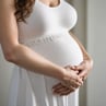 a black and white photo of a pregnant woman