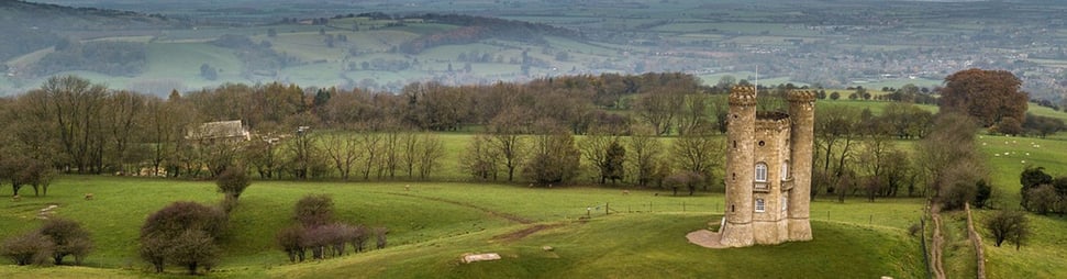 an aerial view of Broadway Tower with rolling hills beyond