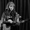 Moss.E playing guitar and singing on stage at Ramsgate Music hall