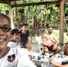 a man with glasses and a white shirt is taking a selfie