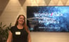 Me posing in front of the Womenhack logo