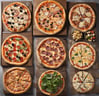 a variety of pizzas and pizza toppings