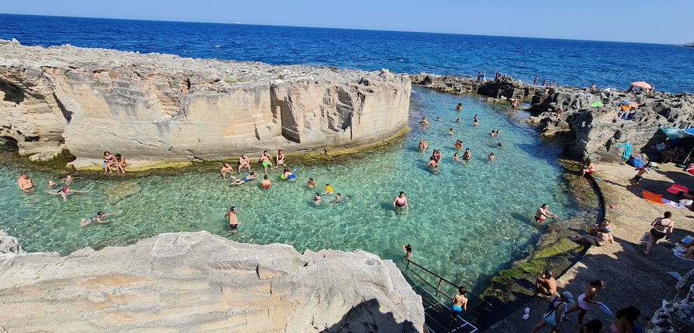 "Grotta della Poesia, Puglia—natural limestone swimming pool with crystal-clear waters, surrounded b