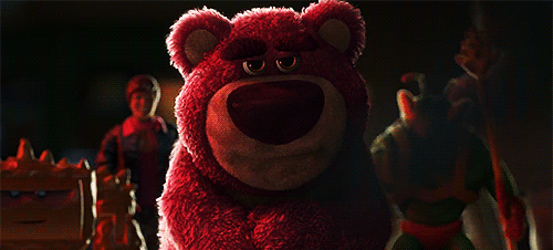 a red teddy bear sitting on a table