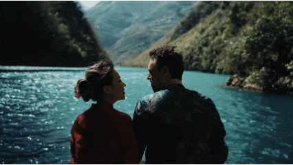an abstract photo of a curved building with a blue sky in the background