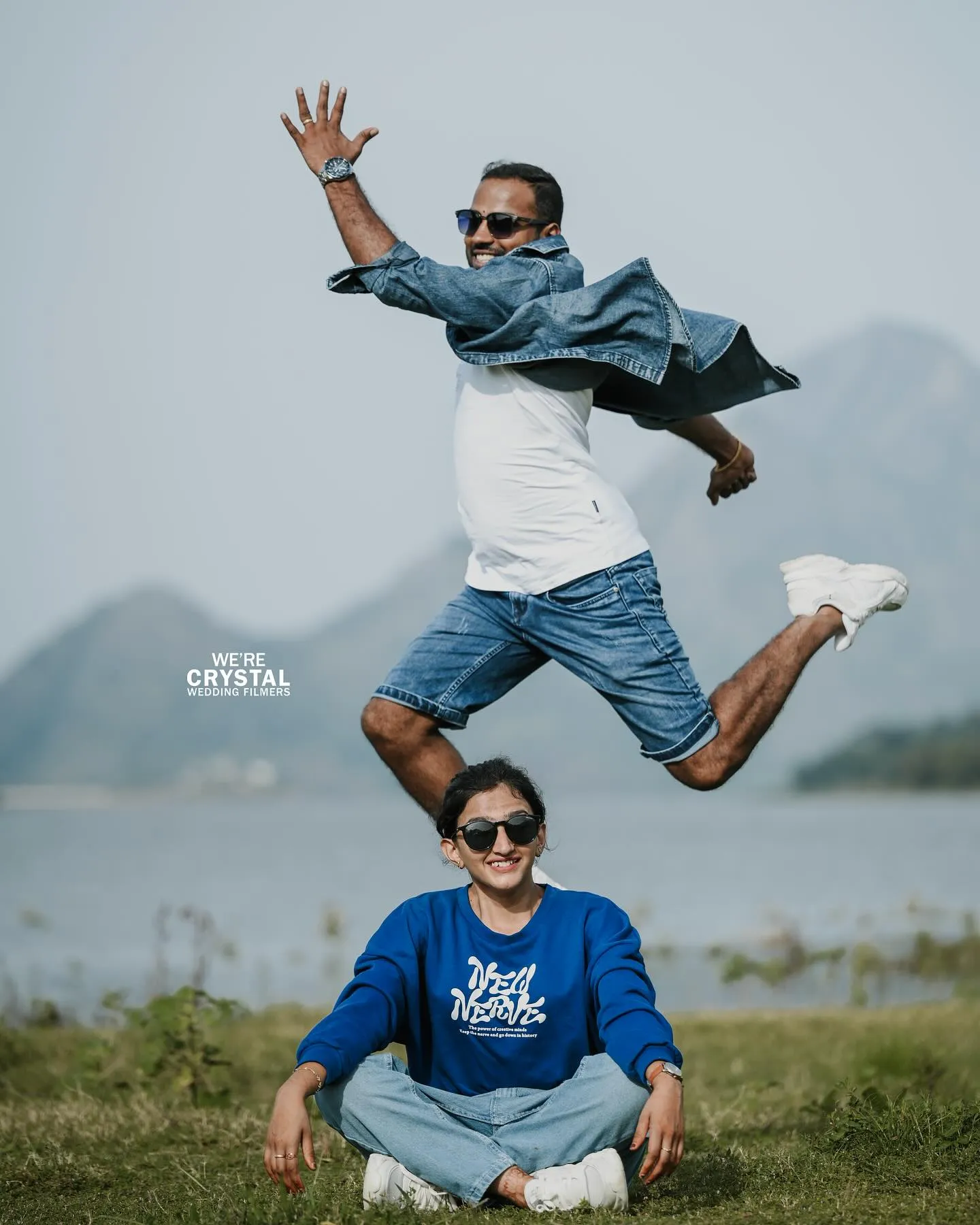 Bride leading the groom by the hand through a scenic Palakkad landscape.