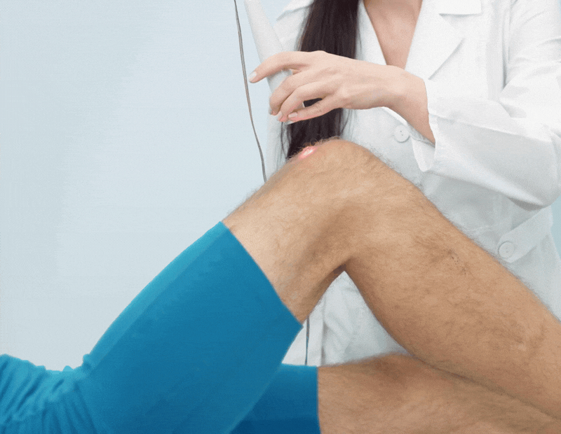 low level laser therapy on client's knee
