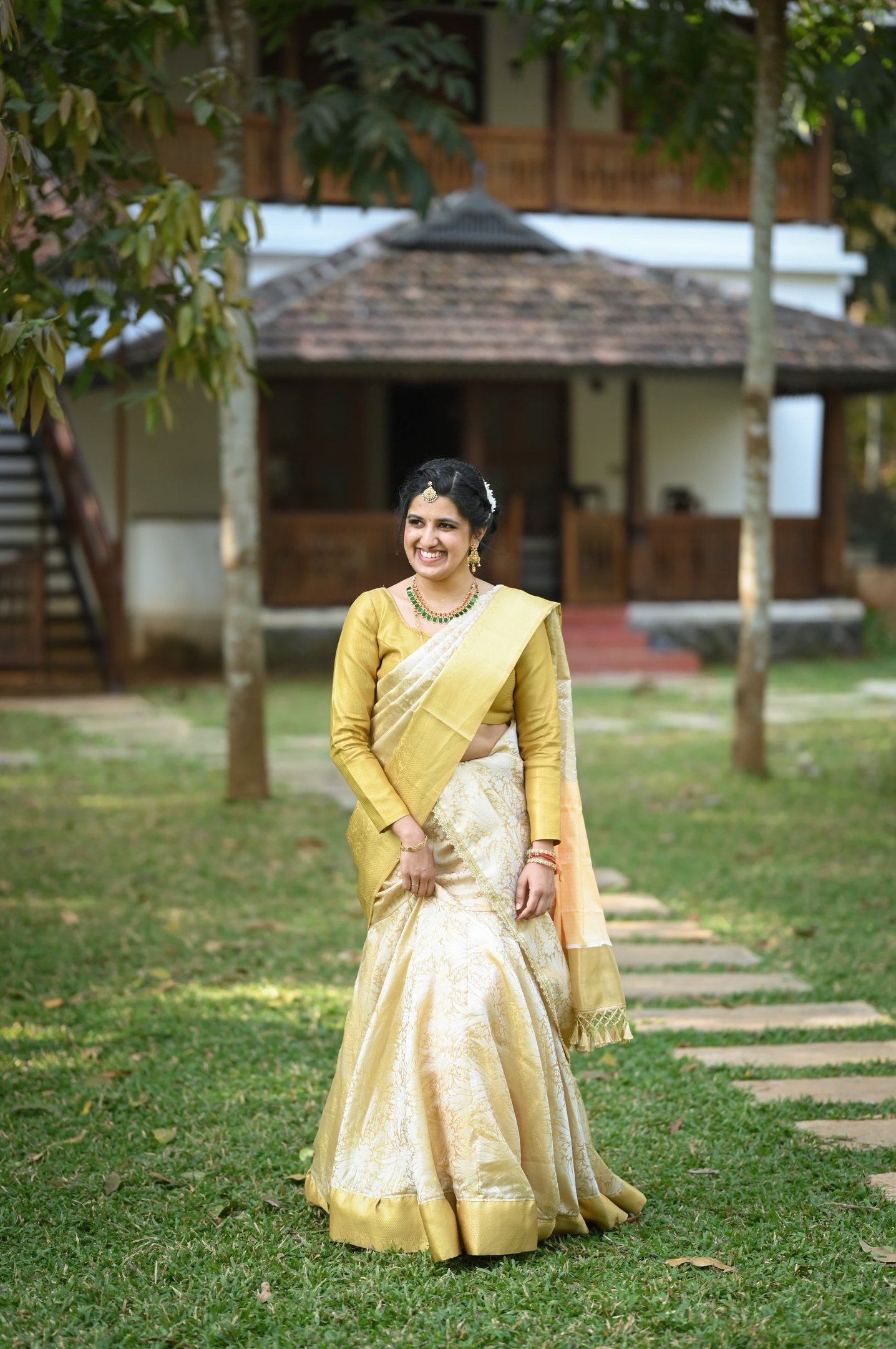 bride wearing a rare traditional looking white saree on her intimate wedding celebration in kerala