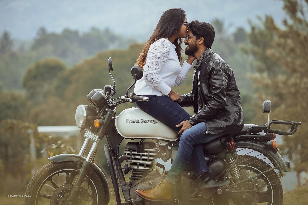Elegant save the date photography with a couple in formal wear by the water in Kerala.