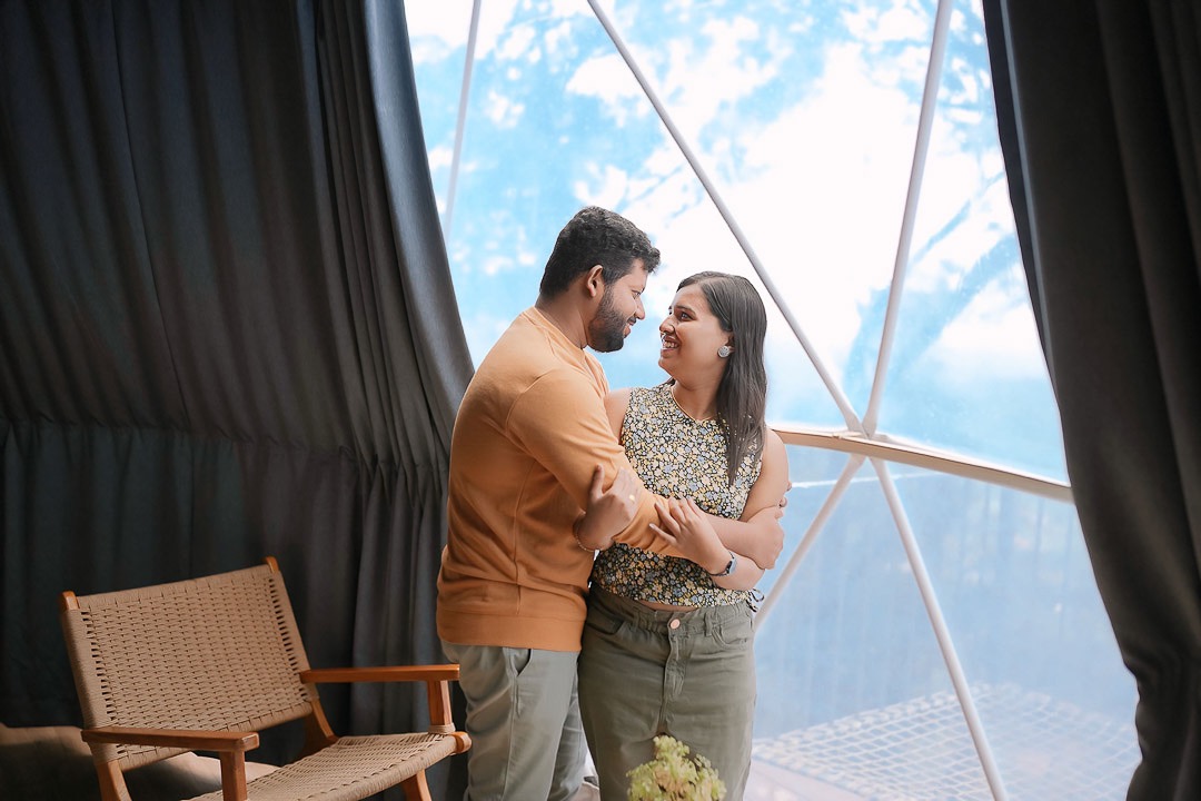 Pre-wedding photo capturing a tender moment between a couple in a forest in Kerala.
