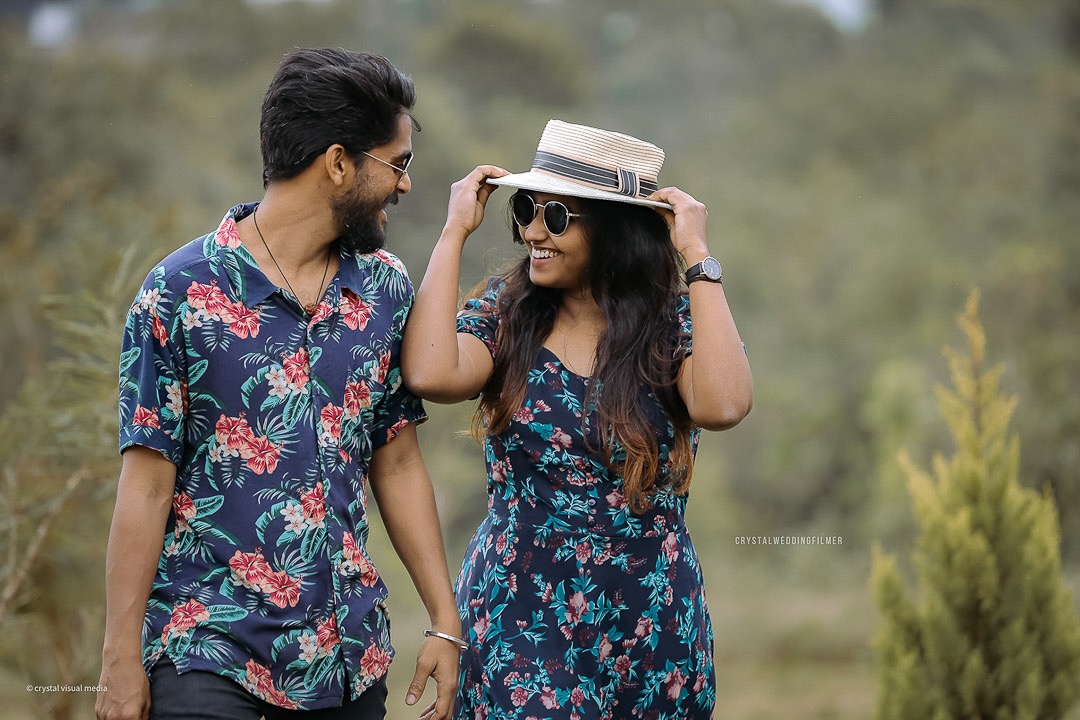 Couple posing with traditional Kerala props for their fun save the date shoot.