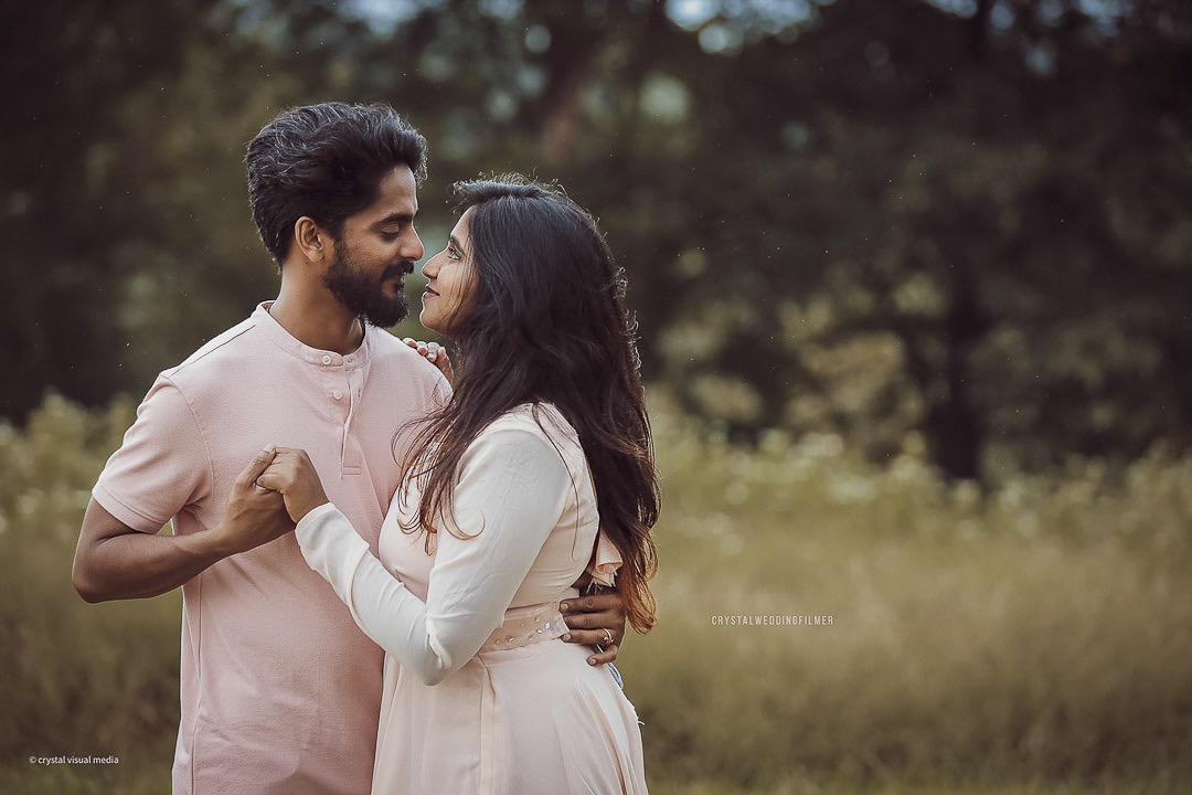 Save the date photography showcasing a couple against a beautiful Kerala landscape at sunset.