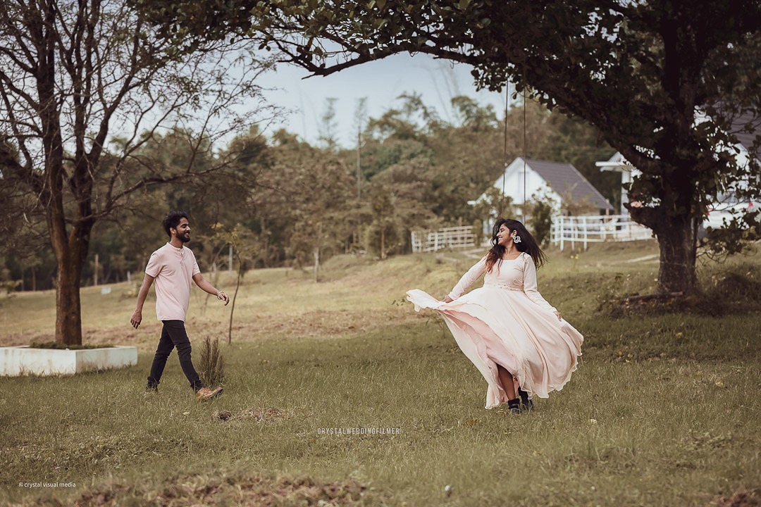 Playful and fun save the date photo of a couple running in Kerala.
