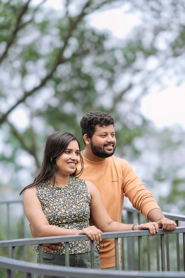 Couple sharing a romantic moment by a waterfall in Kerala for a save the date shoot.