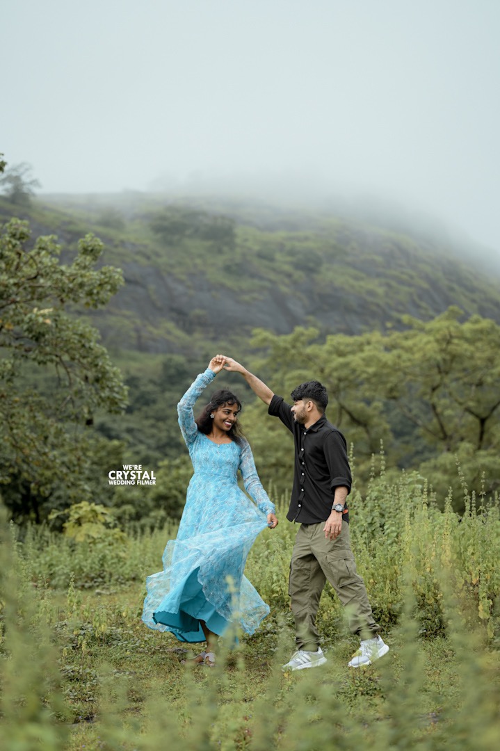 Couple posing for a save the date photo in a lush green setting in Kerala.