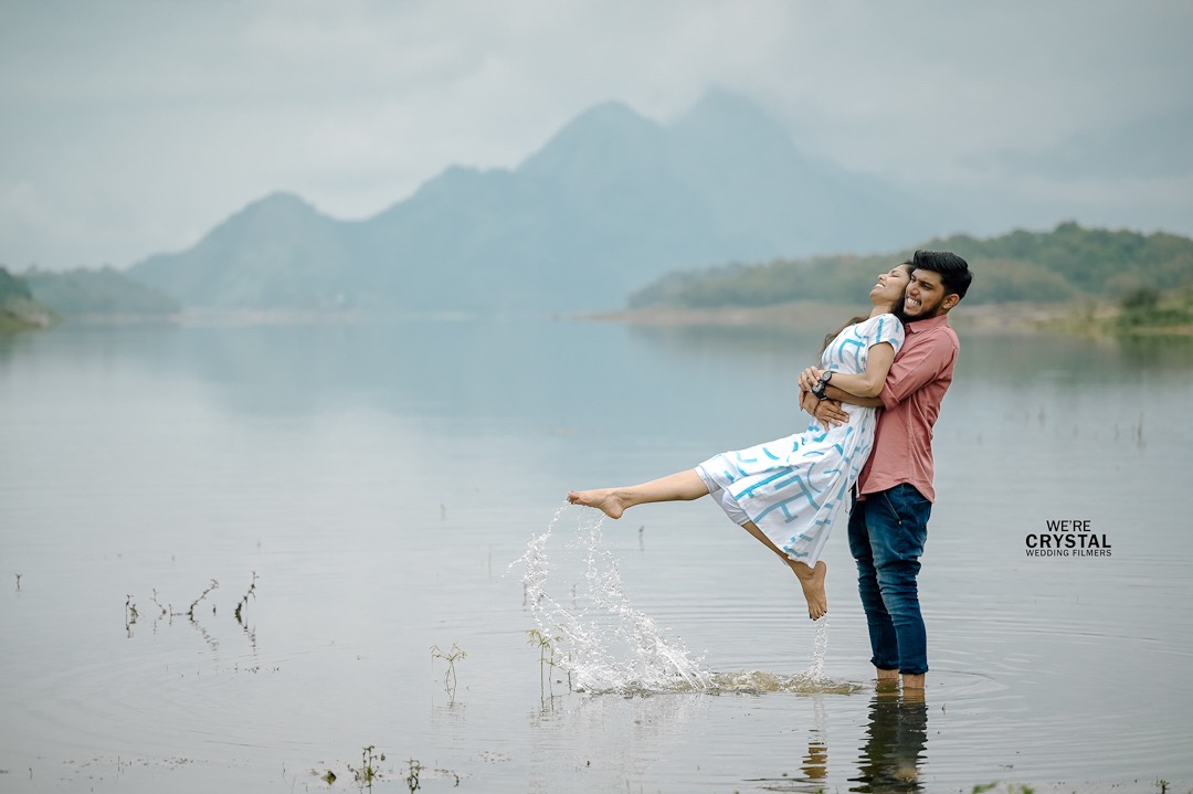 Romantic Kerala save the date photography featuring a couple in an intimate pose by the water.