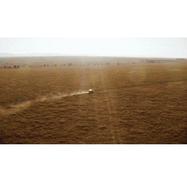an abstract photo of a curved building with a blue sky in the background