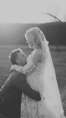 a bride and groom kissing on the beach