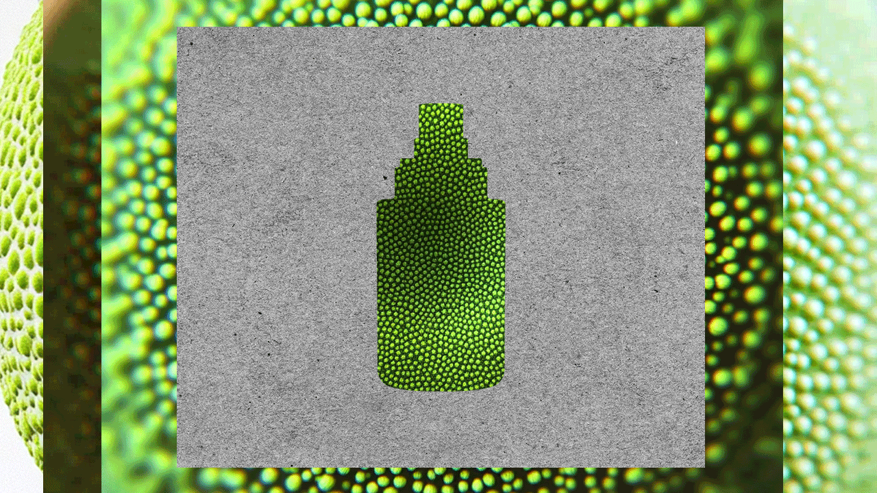 a bottle of liquid sitting on top of a green object