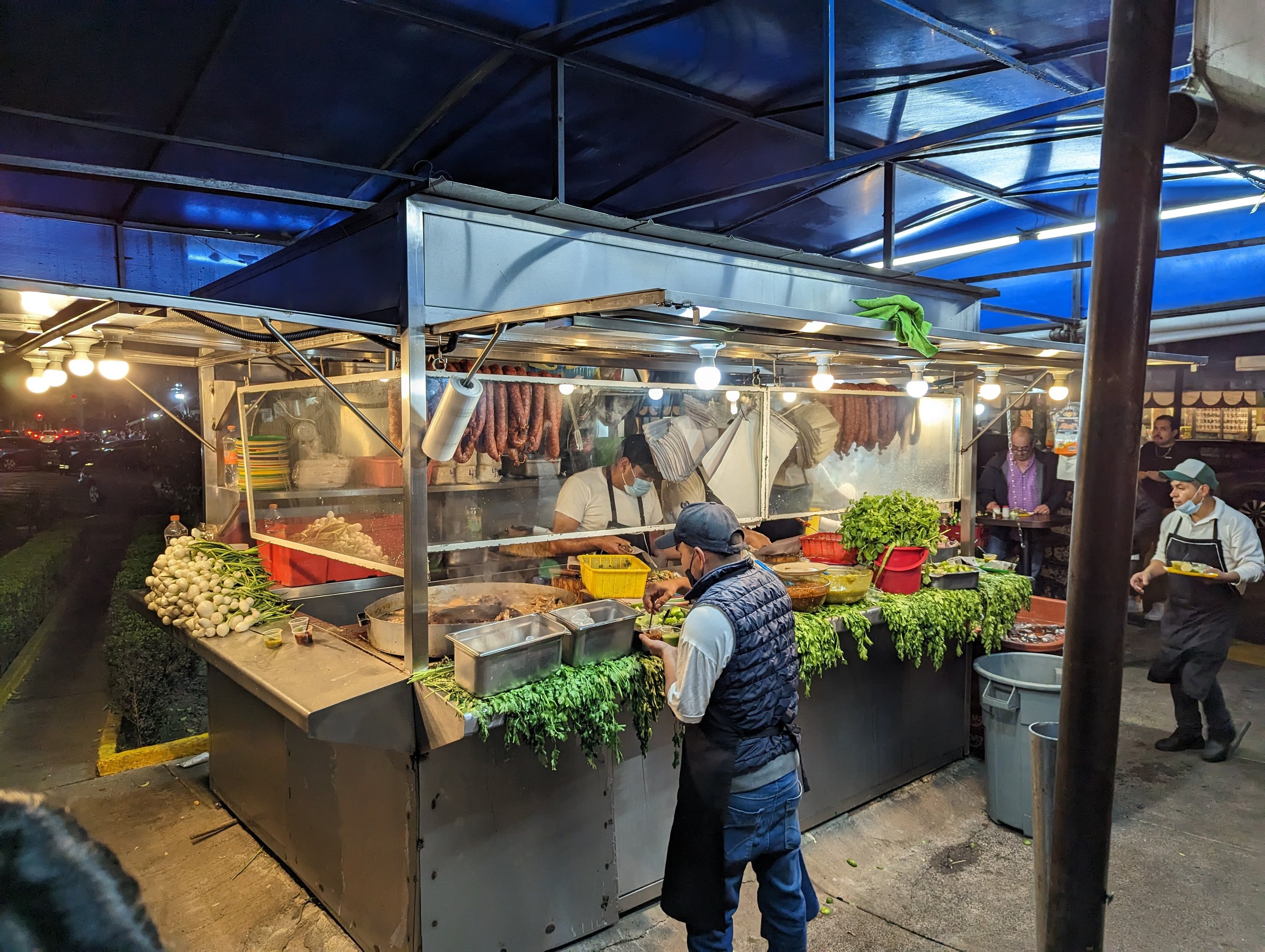 Late-night street tacos in Narvarte, Mexico City - grilled meats and neon-lit taqueria atmosphere