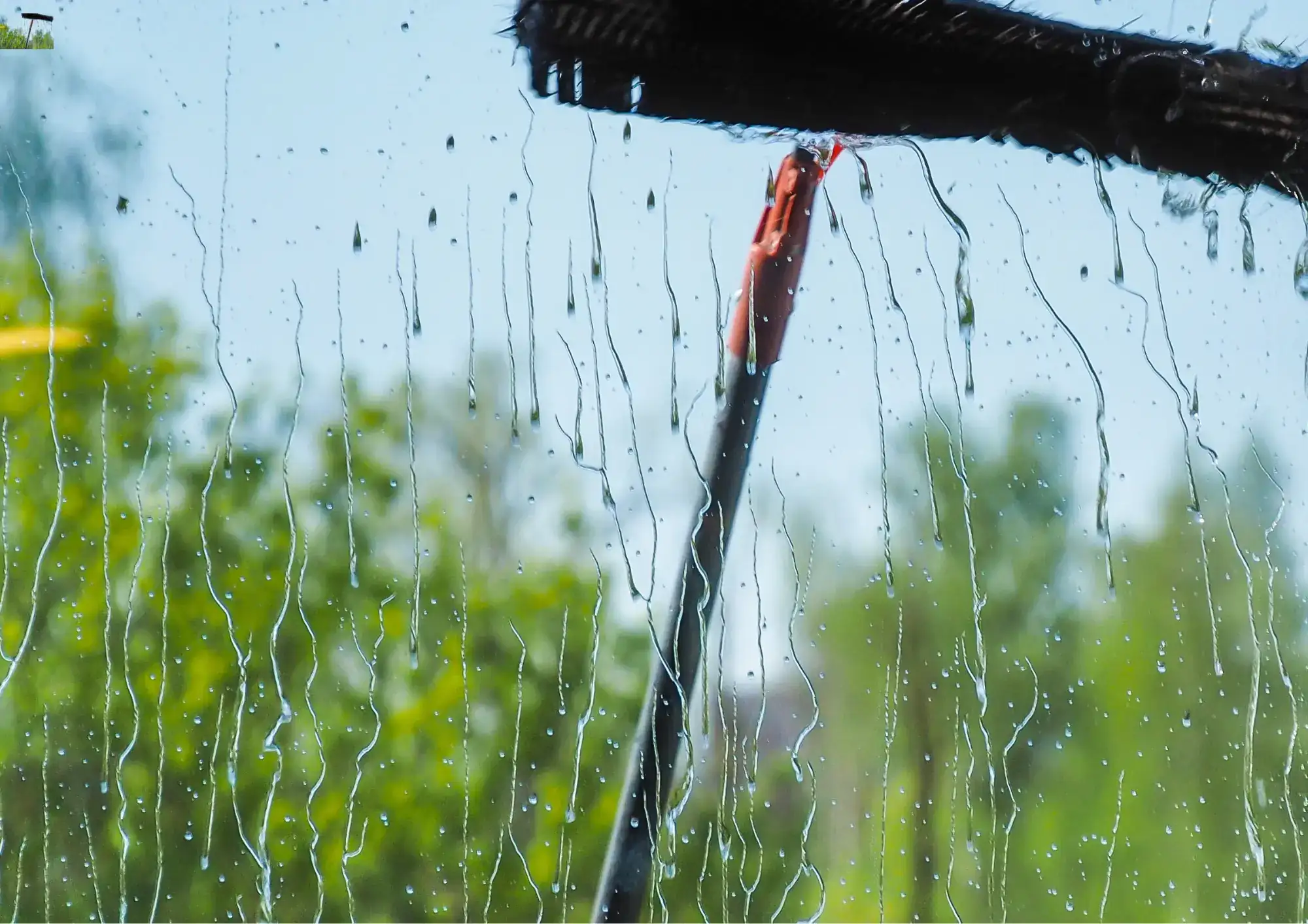 Water-fed pole window cleaning for streak-free results on a residential property