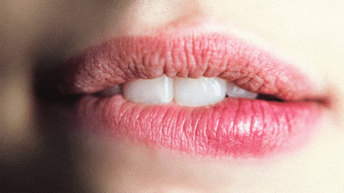 a woman's lips showing her biting her lip