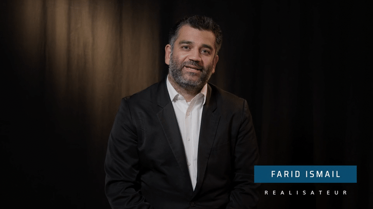 person holding pencil near laptop computer