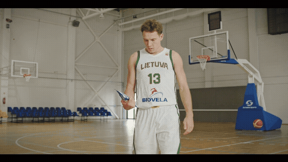 a man in a white jersey and a basketball player eats Biovela products