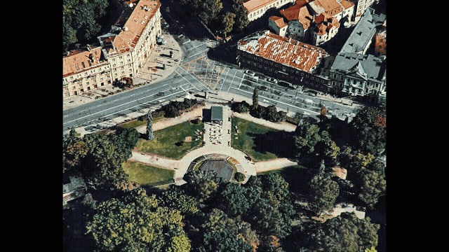 a city street scene with a clock tower in the middle of the picture