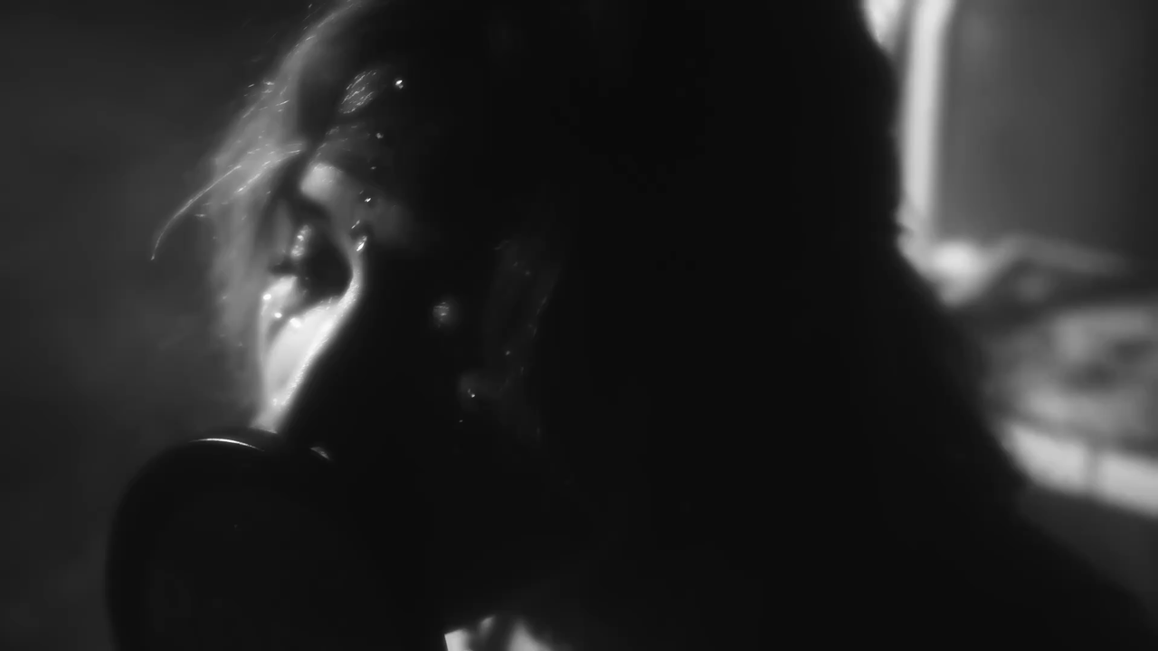 an abstract photo of a curved building with a blue sky in the background