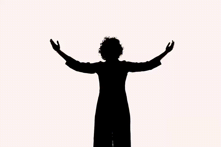 a woman playing a violin in front of a microphone