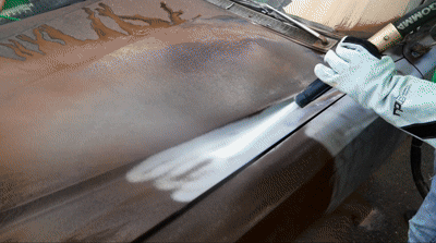 an abstract photo of a curved building with a blue sky in the background